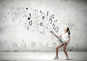 Young pretty girl in shorts and shirt playing imaginary guitar